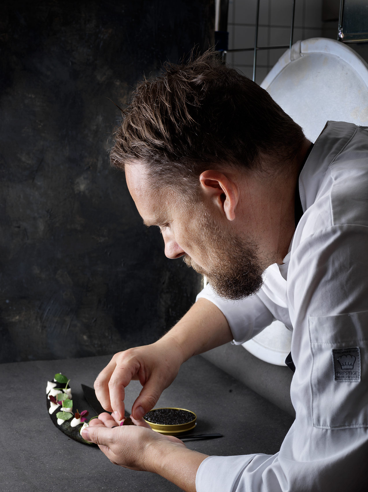 Chef Rasmus Kjær arranging food for Gastro magazine