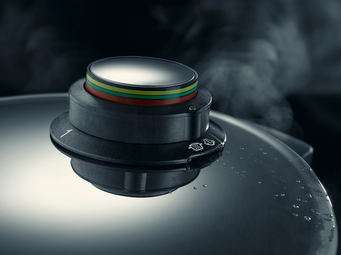 detail of pressure cooker with steam pot on dark background